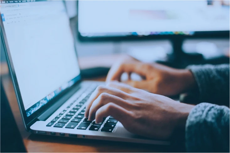 Person typing on laptop